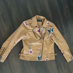 Nwot Vintage Camel Colored Faux Leather Studded Jacket With Embroidery. Motorcycle Jacket Style. Double Option Zipper And Adjustable Side Buckle Straps For Perfect Fit. Sleeves Have Embroidery, Zippers And Studs And Back Of Jacket Is Lined With Studs. Pit To Pit Approx 19” Total Length 23” Size M #Vintage #Leatherjacket #Motorcycle Jacket #Embroidery #Y2k Brown Floral Embroidered Fall Outerwear, Brown Floral Embroidery Outerwear For Fall, Brown Floral Embroidered Outerwear For Fall, Winter Brown Outerwear With Floral Embroidery, Brown Floral Embroidered Winter Outerwear, Brown Floral Embroidered Outerwear For Winter, Embroidered Leather Jacket For Fall, Fall Beige Outerwear With Floral Embroidery, Beige Floral Embroidered Outerwear For Fall