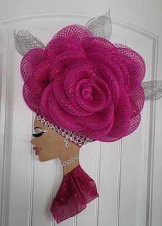 a woman's head is adorned with pink mesh flowers and silver sequins