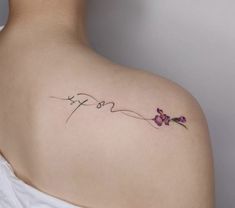 a woman's back shoulder tattoo with the word love written in cursive writing