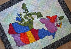 a quilted map of the united states is displayed on a tablecloth with black border