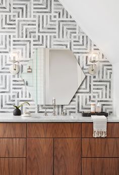 a bathroom vanity with a mirror and lights on it