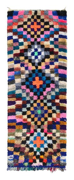 a multicolored rug with fringes on the bottom and sides, all in different colors