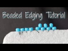 the beaded egging pattern is shown with blue beads on top of white fabric