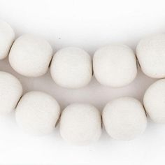 white cotton balls are arranged in a row