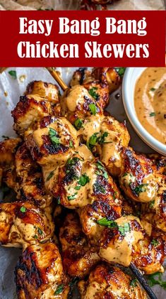 grilled chicken skewers on a plate with dipping sauce