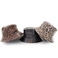 This reversible bucket hat features waterproof leopard print on one side and a soft stylish canvas on the other. It is reversible and a perfect piece to match your activity or outfit for the day. Just roll it up and toss in your bag to take this trendy bucket hat with you. Product Features: Reversible Solid or Leopard Pattern UVA/UVB Sun Protection Lightweight Durable Material Great for any Outdoor Activity or Fashionable Event Waterproof Material Foldable for Easy Travel Authentic CC Branding a Trendy Black Reversible Bucket Hat, Trendy Reversible Outdoor Hats, Leopard Bucket Hat, Bucket Hat Fashion, Kids Mittens, Kids Bucket Hat, Branded Caps, Reversible Bucket Hat, Kids Beanies