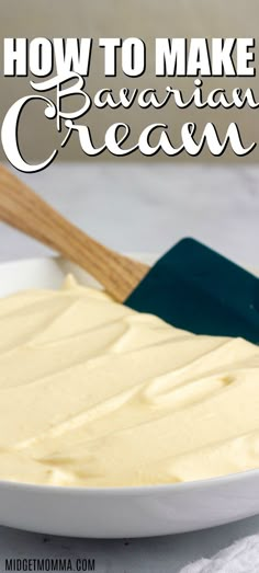 a white plate topped with cream next to a wooden spatula