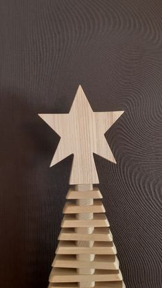 a wooden christmas tree shaped like a star