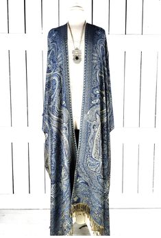 Blue tribal pashmina kimono cover up jacket with custom length and fringe detail Measurements...taken flat - width across seam to seam: 46" -length in photo: 48" - maxi length is as selected with or without fringe Features... - lovely soft woven medium weigh pashmina fabric -custom optional fringe and length - bohemian oversized flowing design - cardigan style with an open front and generous arm holes - universal design allows a comfortable fit for small through plus sizes - the perfect layering piece that can easily be dressed up or down - wrinkle resistant - handmade with love by me in California Add the matching hood... https://www.etsy.com/listing/1283867624/hood-only-add-on?click_key=96eed8d398922f6c25c5d7da55769cfa9eecb034%3A1283867624&click_sum=b755db4a&ref=shop_home_active_12&frs=1 Long Sleeve Fringe Kimono For Festivals, Long Sleeve Festival Kimono With Fringe, Festival Long Sleeve Kimono With Fringe, Bohemian Long Sleeve Kimono With Fringe, Bohemian Blue Cape Outerwear, Bohemian Blue Cape-style Outerwear, One Size Bohemian Kimono With Fringe, Bohemian Fringe Kimono One Size, Bohemian One Size Fringe Kimono