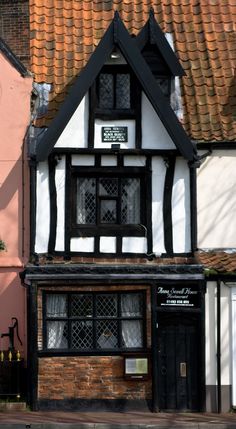 an old building with black and white trim