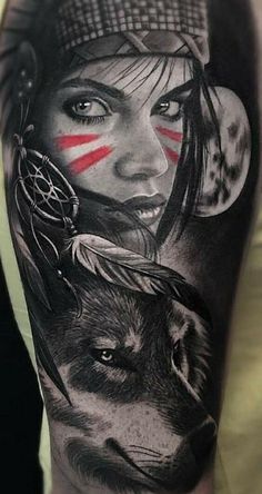 a woman's arm with tattoos on it and an image of a wolf in the background