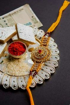 a plate with some food on top of it and a yellow tassel next to it