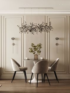 an elegant dining room with white walls and wood flooring, round table surrounded by grey chairs