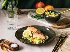 a plate of salmon and vegetables on a table