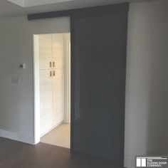 an empty room with sliding doors and hard wood flooring on the side walk way