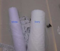 two rolls of white toilet paper sitting next to each other in a tub with the words ivory written on them