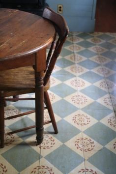 a wooden table and chair in a room with tile flooring that looks like it has been cleaned