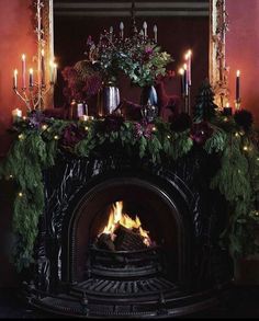 a fire place with candles and christmas decorations