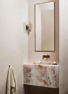 a marble sink and mirror in a bathroom