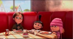 an animated scene with three people sitting at a table in front of the movie characters