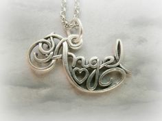 A gorgeous calligraphy charm writing Angel, with a small heart in the middle.It is so elegant cute and beautiful! **This listing is for a silver plated / gold plated angel charm with a rhodium plated or gold plated chain** ##IMPORTANT!##Please inform me at the checkout what item you want, and what size you wish your chain to be. I have 16'' chains and 18'' chains AVAILABLE. Sterling silver charm and chain also available - Cost 25 dollars.Contact me for custom orders..:) Cute Silver Pendant Charm Necklace, Nickel Free Silver Pendant Name Necklace, Cute Silver Heart Pendant Jewelry, Meaningful Silver Pendant Charm Necklace, Cute Sterling Silver Charms Jewelry, Cute Silver Jewelry For Mother's Day, Cute Sterling Silver Jewelry Gift, Sterling Silver Initial Pendant Charm Necklace For Mom, Delicate Sterling Silver Charm Necklaces