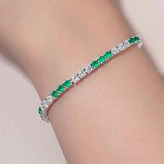 This sparkly tennis bracelet is set with Lafonn's signature Lassaire round cut simulated diamonds and simulated round cut emeralds in sterling silver bonded with platinum. Bracelet measures 7.25 inches long Includes bracelet box Ships fully insured to point of delivery All orders placed out of NY state (ordered by an out of state resident) are tax free