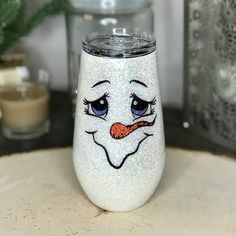 a glass with a face painted on it