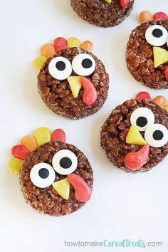 three cookies decorated like turkeys with googly eyes and cereal in the shape of faces