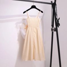 Spring A-line Midi Dress With Bow, Beige Summer Dresses With Bow, Spring Daywear Dresses With Bow, Spring Dresses With Bow For Daywear, Spring Daytime Dress With Bow, Spring Dresses With Bow For Daytime, Chic Midi Dress With Bow For Brunch, Beach Cotton Dress With Bow, Summer Midi Dress With Bow