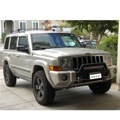 a white jeep parked in front of a house