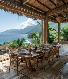 an outdoor dining area overlooking the ocean with wooden tables and chairs set up for dinner