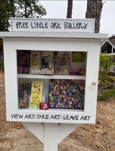 a sign that is on the side of a road with pictures and cards in it