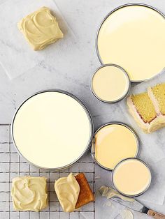 cake batter in tins next to cakes on cooling rack