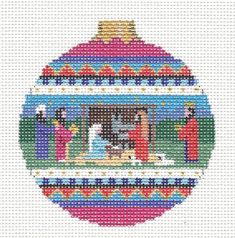 a cross stitch ornament with an image of the birth of jesus on it