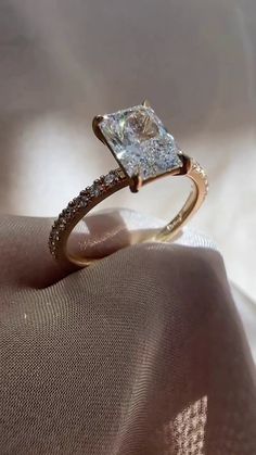 an engagement ring with a cushion cut diamond