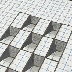 some black and white squares are on the floor with one piece cut out to look like an arrow