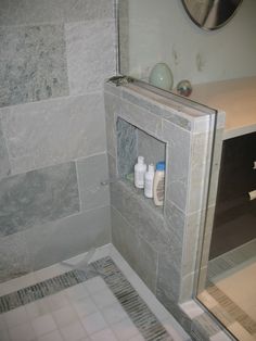 a bathroom with a sink, toilet and shower stall in it's corner area