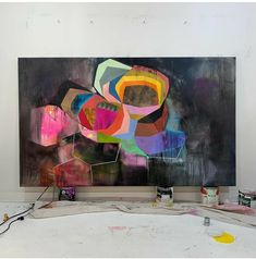 an abstract painting is being worked on in a studio