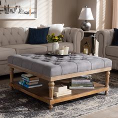 a living room with couches, tables and lamps on the wall in front of windows