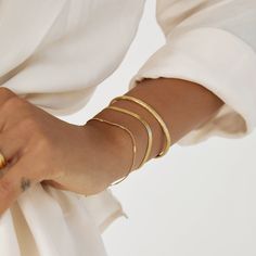 An elegant classic with a whole lot of style, our fine Willa Bracelet is here to create an elevated look for any occasion!﻿ Willa is designed to be stacked with any other gold or textured pieces to create the layering style of your dreams! 14k Gold Plated (1 Micron Thick)  Stainless Steel Base  E-coating for a premium finish  Lead & Nickel Free Elegant Everyday Gold-tone Bangle, Elegant Stackable Chain Bracelet For Formal Occasions, Elegant Formal Stackable Chain Bracelet, Modern Gold Bracelet In Snake Chain Style, Elegant Metal Snake Chain Bracelet, Minimalist Stackable Chain Bracelet For Formal Occasions, Elegant Adjustable Snake Chain Bracelets, Minimalist Stackable Chain Bracelet For Formal Events, Gold Metal Bracelets For Everyday Luxury