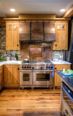 a kitchen with wooden cabinets and stainless steel stove top oven in the center of the room