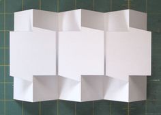 several pieces of white paper are arranged on a cutting board