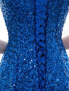 the back of a dress with blue sequins