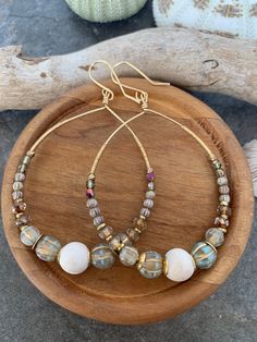 Beautiful spring vibe gemstone beaded hoop earrings  .. crafted with smooth river jasper bead focals  .. paired with an array of gorgeous czech beads accented with african brass beads and hand wire wrap detail. These gold tone hoops measure 3 inches in length and 2 in width . Large Bead Earrings, Bohemian Hoop Earrings With Dangling Round Beads, Bohemian Hoop Earrings With Dangling Beads, Bohemian Dangle Hoop Earrings With Natural Stones, Bohemian Round Earrings With Spacer Beads, Bohemian Hoop Earrings With Natural Stones, Bohemian Hoop Earrings With Natural Stones For Jewelry Making, Bohemian Wire Wrapped Hoop Earrings, Bohemian Wire Wrapped Hoop Earrings For Everyday