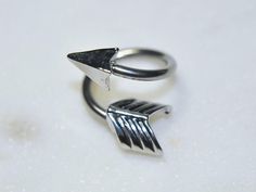 two silver rings with black arrows on them