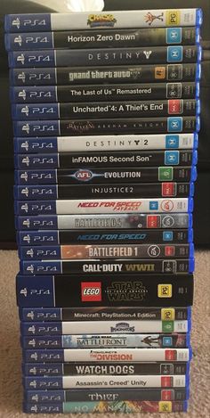 a stack of video games sitting on top of a carpet