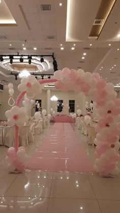 a wedding hall decorated with pink and white balloons