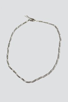 A new take on the classic Fígaro. Solid sterling silver small fígaro style chain with custom hook closure. The hook fits into all links. - Length is approximately 21" - Sterling Silver - Handcrafted in NYC