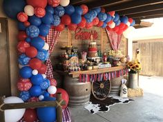 an outdoor bar with balloons and decorations on the outside, along with a cowhide rug