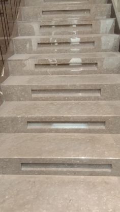 the stairs are lined with marble blocks